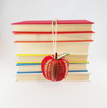 Load image into Gallery viewer, Hanging handmade book ornament in shape of apple
